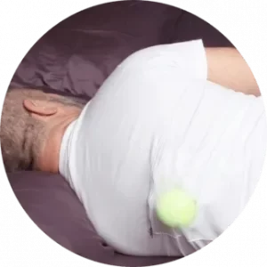 Male sleep on his left side, wearing a tennisball on his back to stop him from snoring